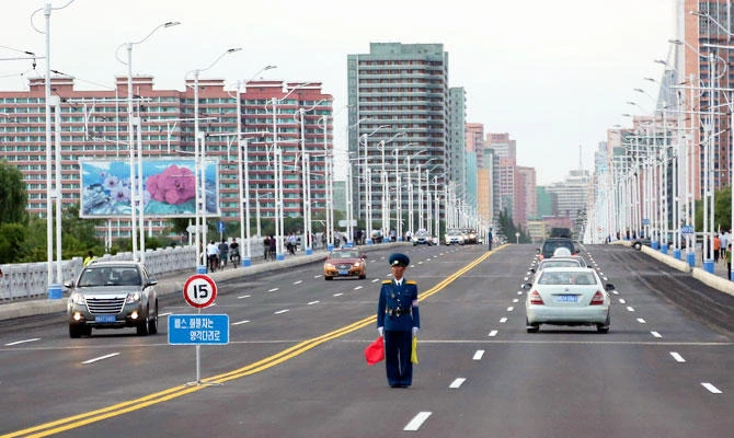 A police man directs traffic on a street lined with apartment buildings in Pyongyang, North Korea, in this June 15, 2018 photo. (AP)