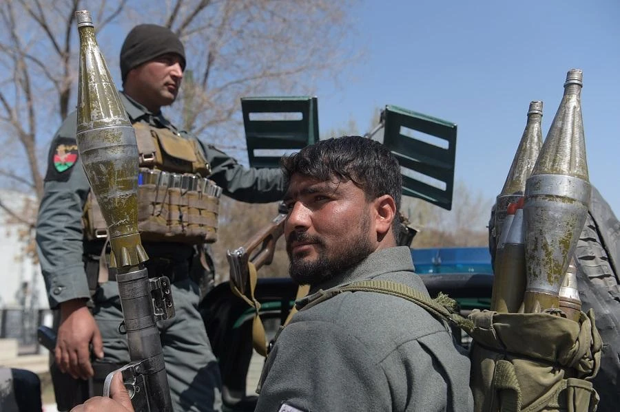 Afghan policemen stand guard near the site of a suicide bombing attack in Kabul on March 21, 2018. (AFP)