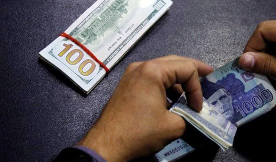 In this file photo, A currency trader counts Pakistani Rupee notes. (REUTERS)
