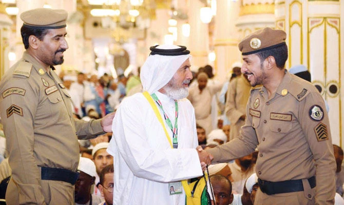 Security officials at the Prophet’s Mosque in Madinah serving a pilgrim with a smile. (SPA)