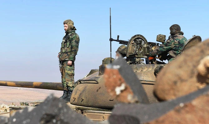 Above, Syrian government forces stand on a tank in Jabal Al-Hass in the southern part of Aleppo province as they advance towards the Abu Duhur military airport in the ongoing offensive against opposition fighters. (AFP)