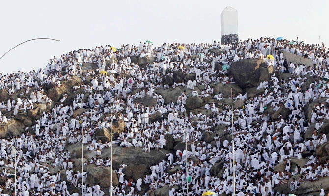 Muslim pilgrims climb Mount Mercy on the plains of Arafat during the peak of the annual hajj pilgrimage near the holy city of Makkah, in this October 25, 2012. (Reuters)