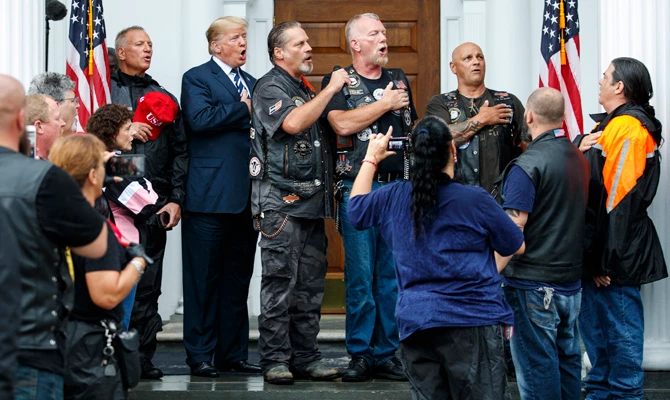 Rain pouring, Trump rages on Twitter and hangs with bikers