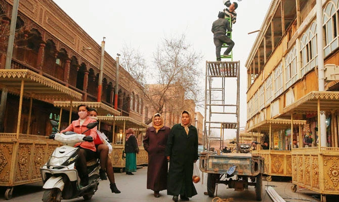 Men install a CCTV camera in a shopping street in the old town of Kashgar, Xinjiang Uighur Autonomous Region, China, in this March 23, 2017 file photo. (REUTERS)