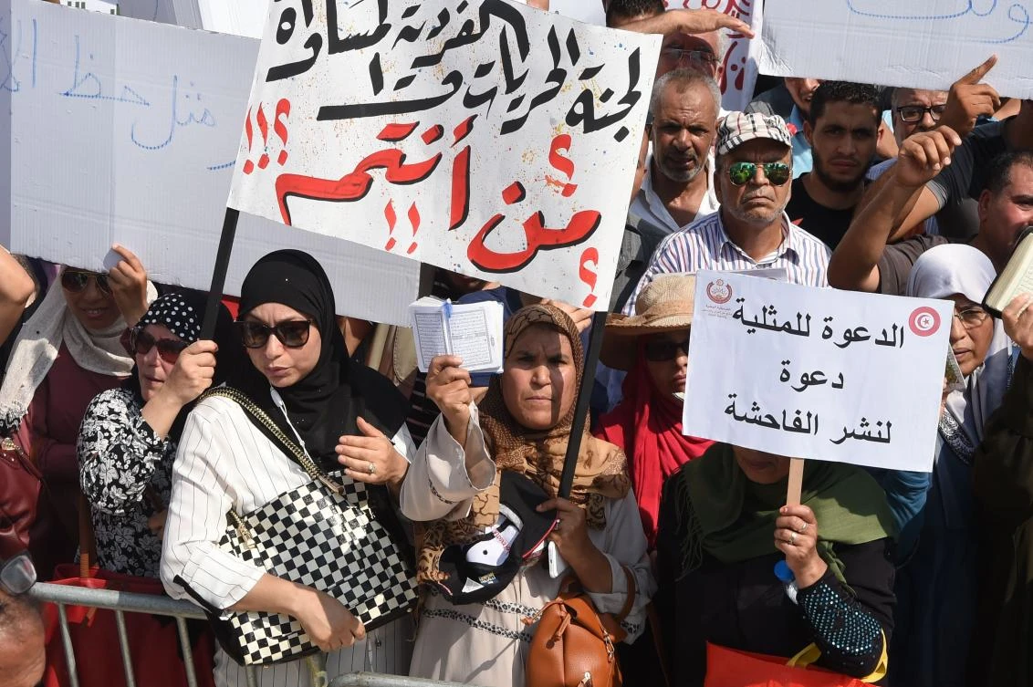 Hundreds of Tunisians shout slogans during a protest against proposed reforms opposed by conservative Muslims that include equal inheritance rights for women and decriminalizing homosexuality, on August 11, 2018 in Tunis. (AFP)