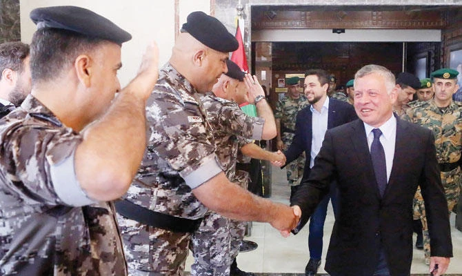 King Abdullah and Crown Prince Hussein during their visit to the Gendarmerie and Public Security Directorates headquarters in Amman on Tuesday. (AFP)