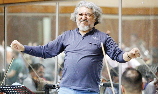 Iraqi National Symphony Orchestra conductor Mohammed Amin Ezzat leads musicians during a rehearsal at Baghdad's School of Music and Ballet. (AFP)