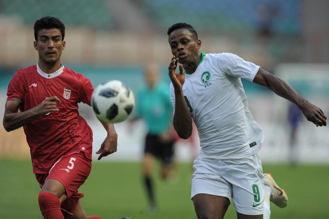 Saudi Arabia's Haroune Moussa Camara fights for the ball with Iran's Alireza Arta in the Asian Games group game between the two nations. (AFP)