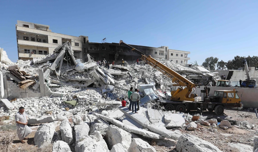 Destroyed buildings following an explosion on Aug. 12 at an arms depot in a residential area in Syria’s Idlib province city of Sarmada. (AFP)