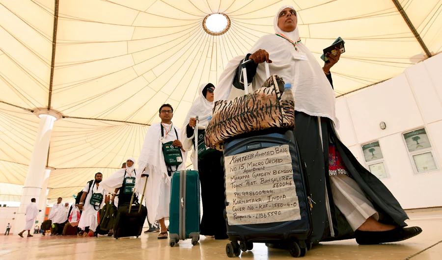 Indian pilgrims arrive at the King Abdulaziz International Airport in Jeddah on August 14, 2018, prior to the start of the annual Hajj pilgrimage in the holy city of Mecakkah. (AFP / Amer Hilabi)
