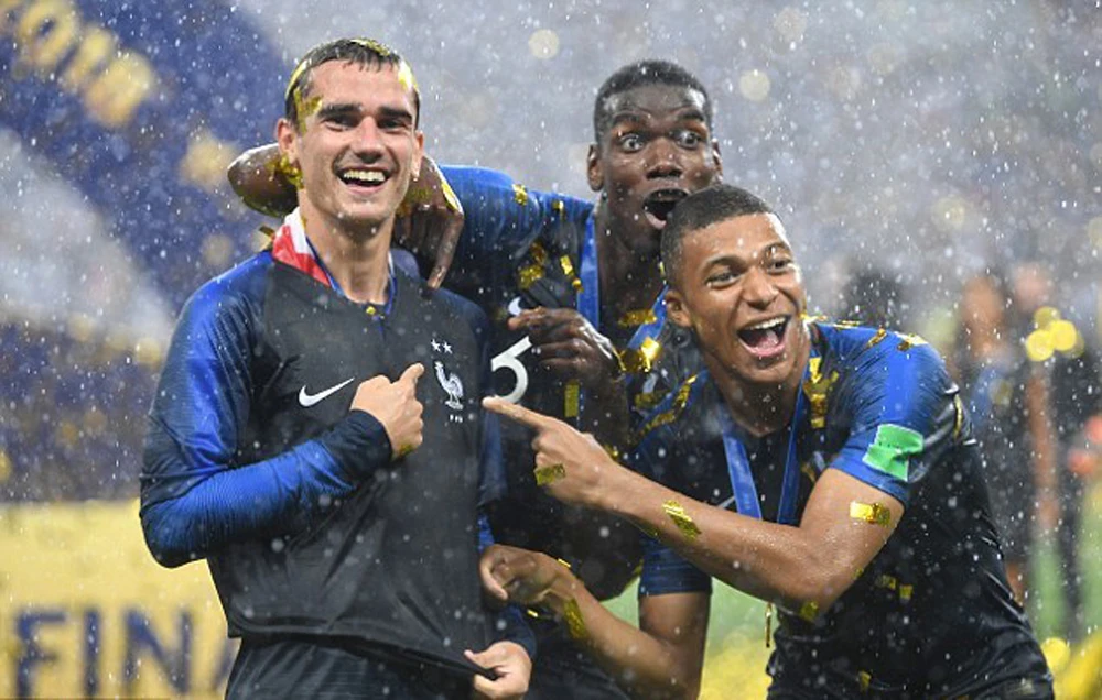 Antoine Griezmann, left, sprung his own 2-star shirt to celebrate World Cup victory, catching Paul Pogba, center, and Kylian Mbappe by surprise. (Getty Images)