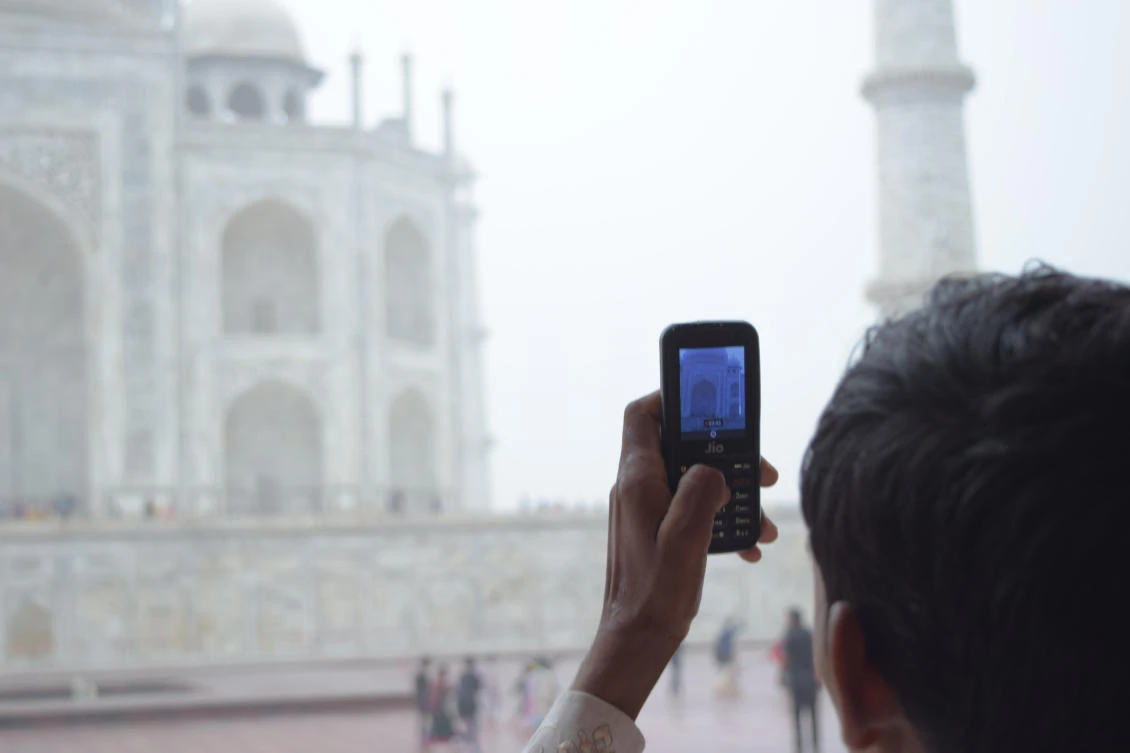 An Indian man takes a picture of the Taj Mahal. India wants to compel technology companies to store their data locally, triggering a backlash from some firms. (Shutterstock)