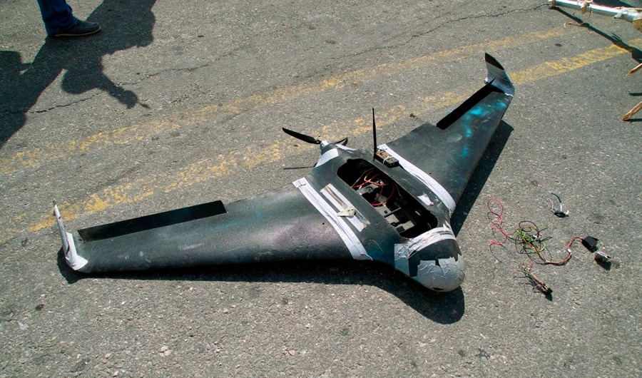 Russian soldiers display the remains of, what they said was, a drone belonging to rebel fighters and was shot down over the base in the Russian air base in Hmeimim in the northwestern Syrian province of Latakia on August 16, 2018. (AFP)