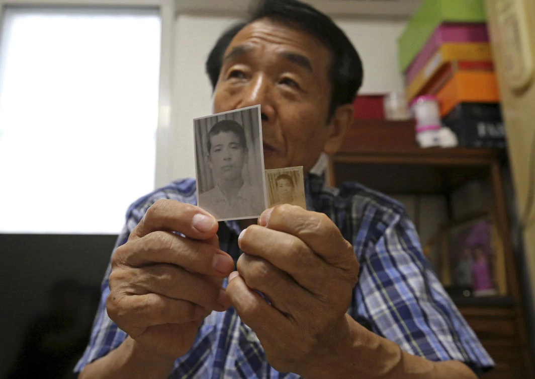 Lee Soo-nam, 76, shows photos of his brother Ri Jong Song in North Korea during an interview at his home in Seoul, South Korea. Lee is among about 200 war-separated South Koreans and their family members who are crossing into North Korea for heart-wrenching meetings with relatives they haven’t seen for decades. (AP Photo/Ahn Young-joon)