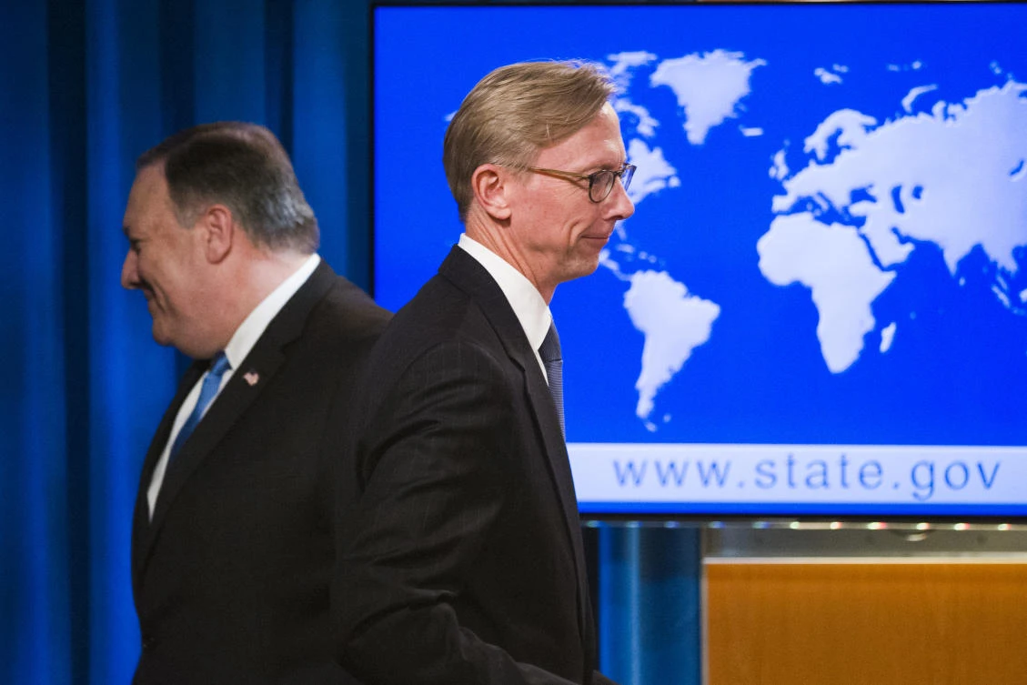 Secretary of State Mike Pompeo, left, leaves the stage as Brian Hook, special representative for Iran, walks to the podium to speak about the creation of the Iran Action Group at the State Department, in Washington, Thursday, Aug. 16, 2018. (AP/Cliff Owen)