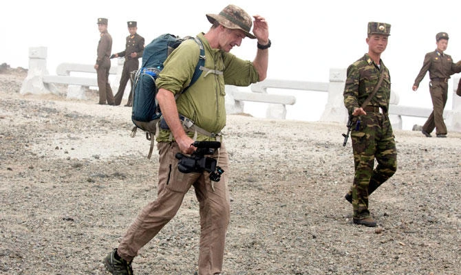 In this Saturday, Aug. 18, 2018, photo, Roger Shepherd of Hike Korea walks past North Korean soldiers while leading a hike on Mount Paektu in North Korea. (AP)