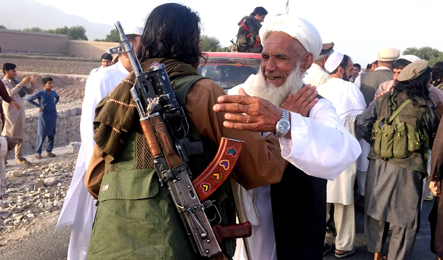 In this file photo, Taliban fighters gather with residents to celebrate a three-day cease fire marking the Islamic holiday of Eid al-Fitr, in Nangarhar province, east of Kabul, Afghanistan. (AP)