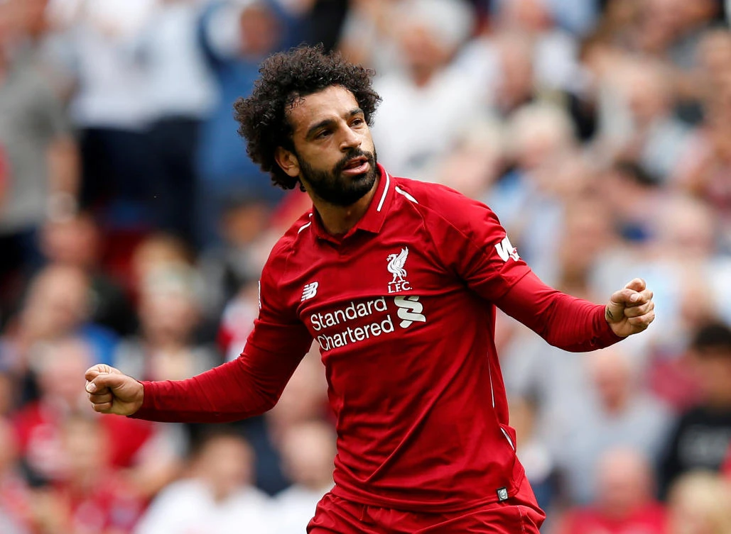 Liverpool's Mohamed Salah celebrates scoring their first goal against West Ham United in the opening game of the Premier League. (Reuters)