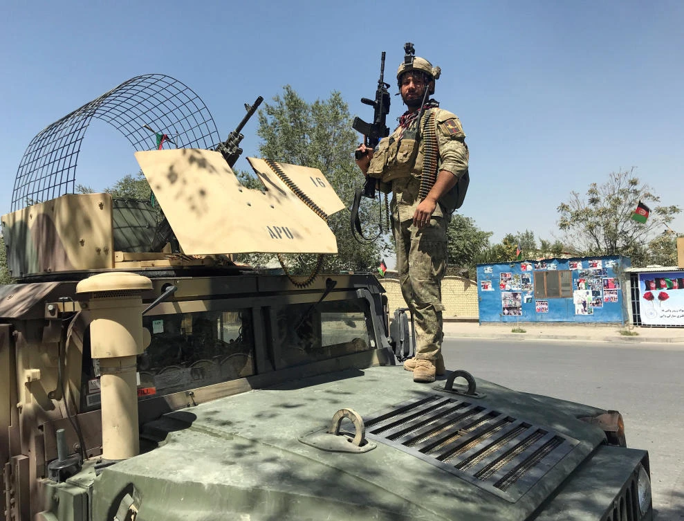 A member of the Afghan security forces keeps watch at the site of an attack in Kabul on Tuesday, August 21. (Reuters)