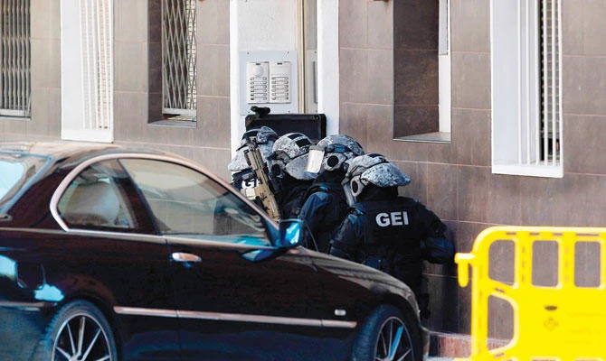 Special police forces prepare to raid the apartment building of a man who attacked a police station in Cornella near Barcelona on Monday. (AFP)