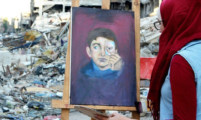 In Syria’s Yarmuk, artists paint amid the ruins