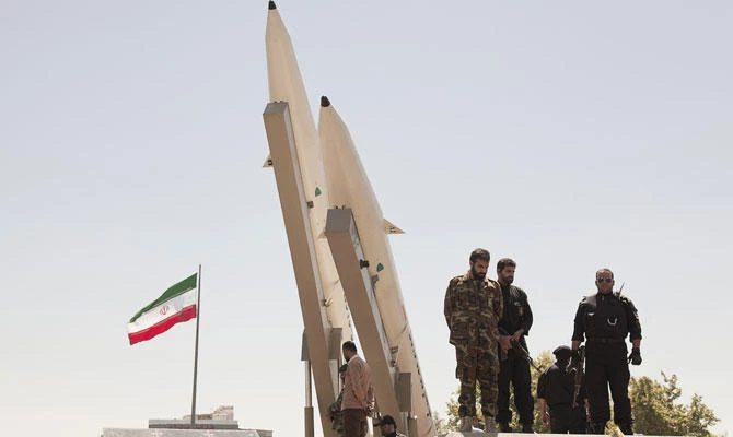 Members of the Iranian Revolutionary Guard Corps flaunt Middleware missiles, Zulfiqar rocket, on display during a rally in Tehran. (Shuttersock)