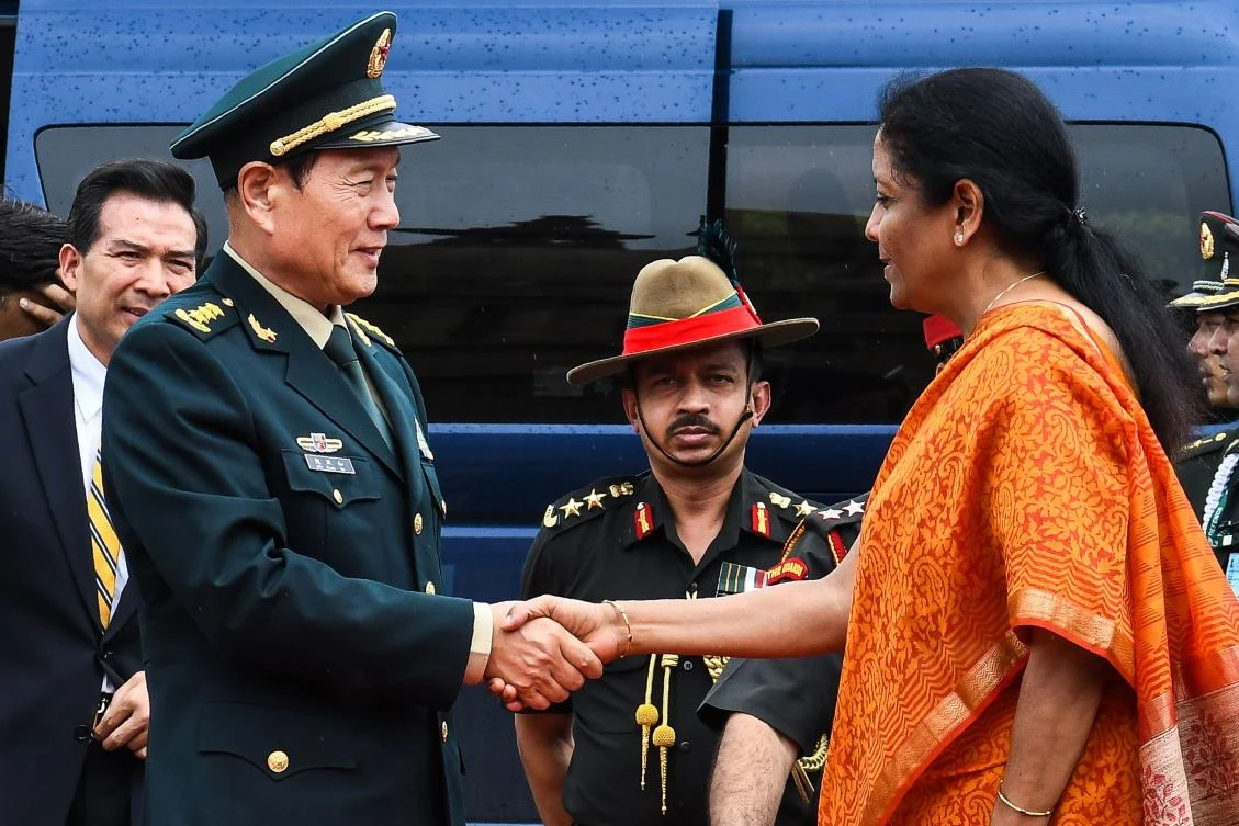 China’s Defense Minister Wei Fenghe shakes hands with Indian Defense Minister Nirmala Sitharaman as he attends a guard of honor ceremony in New Delhi on Wednesday, August 23. (AFP)