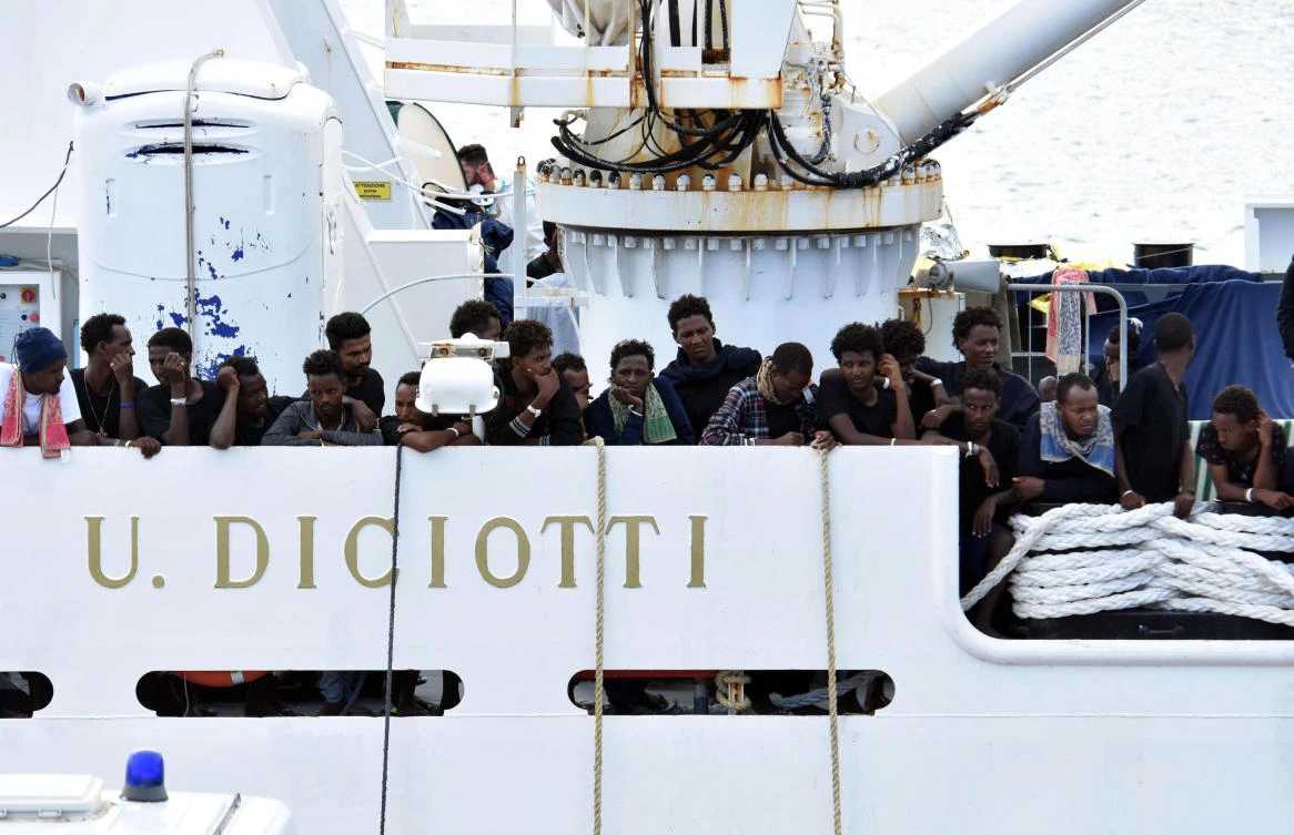 Migrants aboard the Italian Coast Guard ship Diciotti gather on the deck as they await decisions in the port of Catania, Italy, Friday, Aug. 24 2018. (AP)