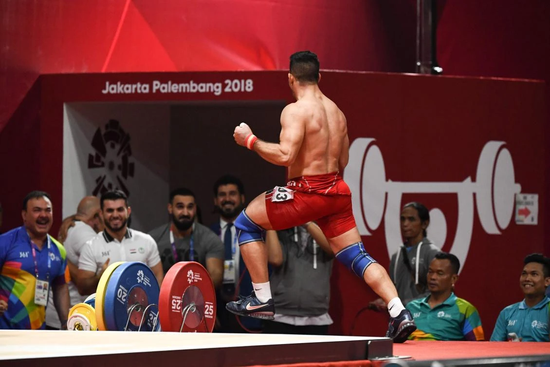 Iraq's Safaa Al-Jumaili reacts after his winning lift, gaining him the gold medal in the men's 85kg Group A weightlifting event at the 2018 Asian Games in Jakarta. (AFP)