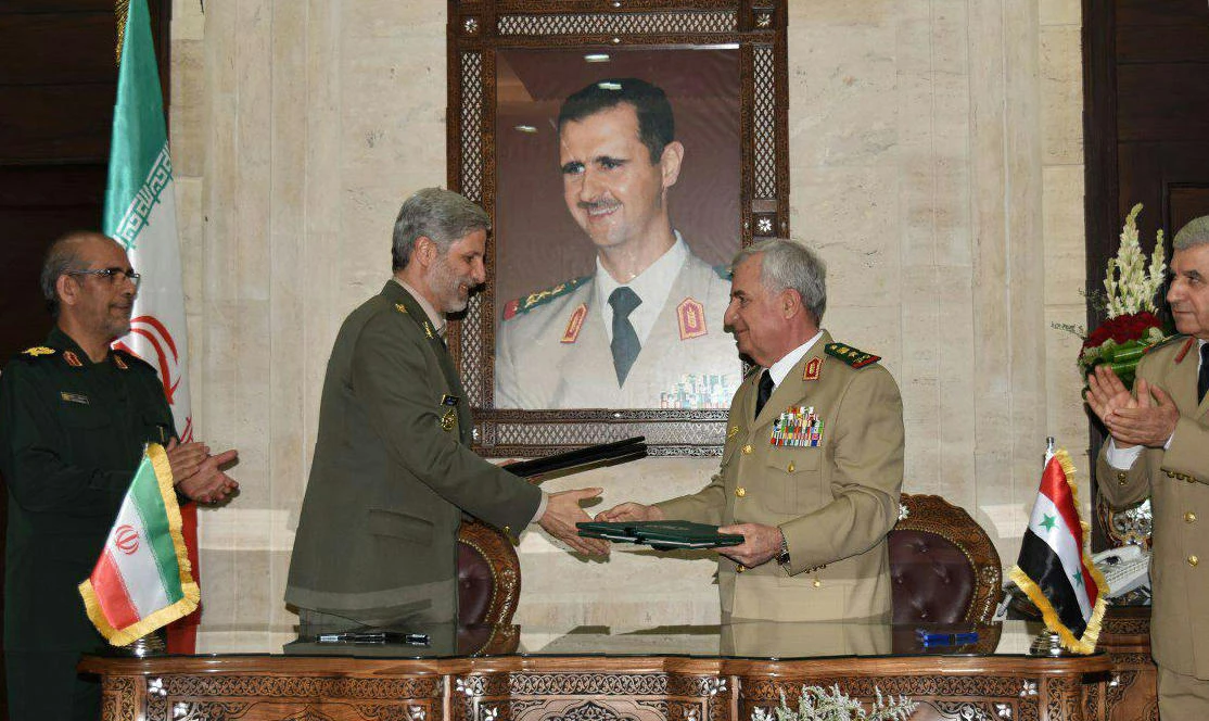 Iranian Defence Minister Amir Hatami (L) meeting with his Syrian counterpart Abdullah Ayoub (R) in the capital Damascus. (AFP)
