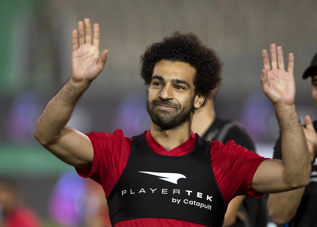 In this June 9, 2018, file photo, Egyptian national team football player and Liverpool's star striker Mohamed Salah smiles as he greets fans during the final training of the national team at Cairo Stadium in Cairo, Egypt. (AP)