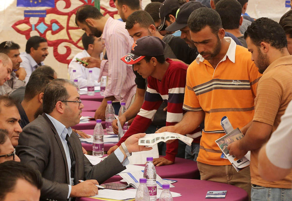 Syrian refugees queue to register their names at the Zaatari office for employment at the Zaatari refugee camp, 80 kilometers (50 miles) north of the capital Amman. (File photo / AFP)