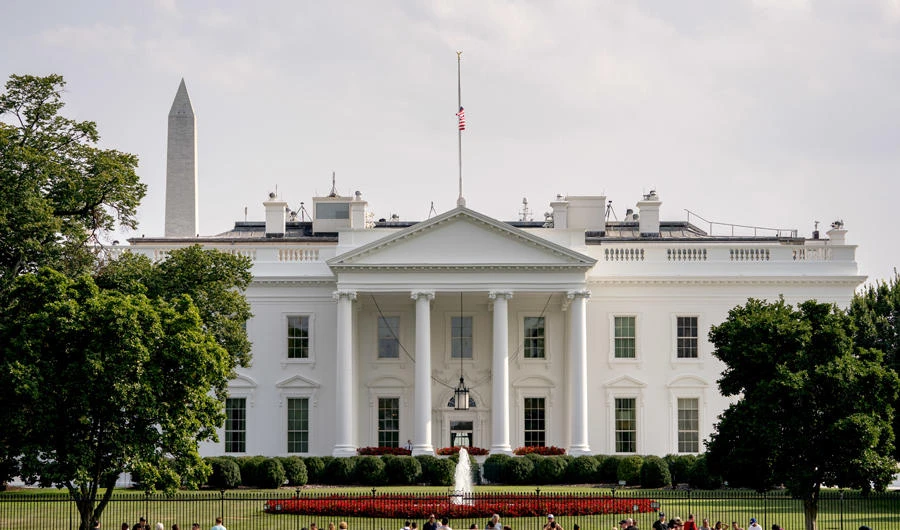 The American flag files at half-staff at the White House, Monday afternoon, Aug. 27, 2018, in Washington. (AP Photo/Andrew Harnik)