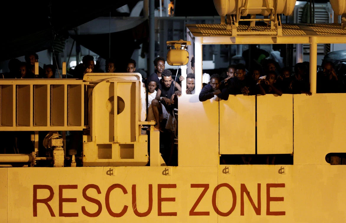 Migrants wait to disembark from Italian coast guard vessel “Diciotti” at the port of Catania, Italy, August 25, 2018. Picture taken August 25, 2018. (Reuters)