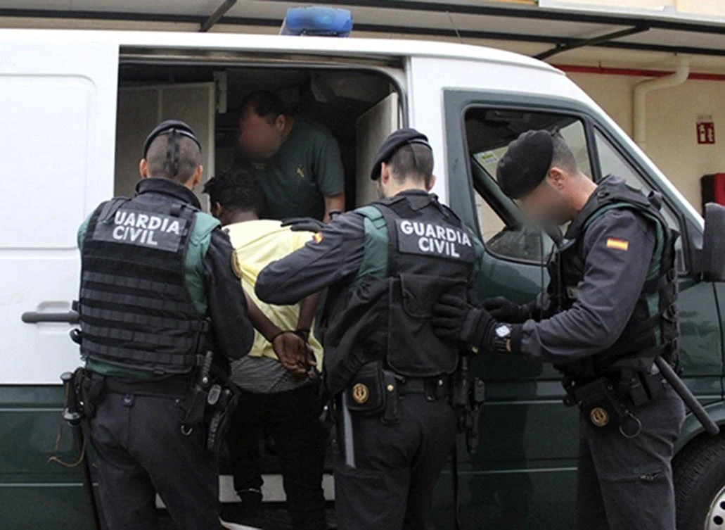 This handout image released by Spanish Guardia Civil on August 28, 2018 shows Spanish civil guards arresting an unidentified man in the Spanish enclave of Ceuta. (AFP)