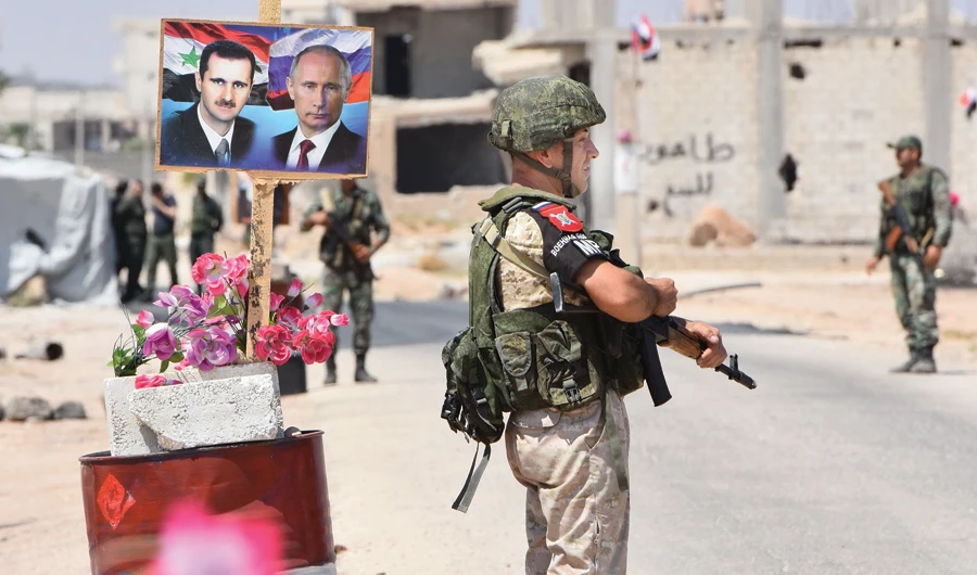 Members of Russian and Syrian forces at the Abu Duhur crossing on the eastern edge of Idlib province. (Files/AFP)