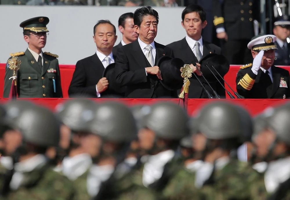 Japanese Prime Minister Shinzo Abe (C) reviews soldiers of the Ground Self-Defense Force during a military parade at Camp Asaka in Asaka, Saitama prefecture, on October 23, 2016. (File/ AFP)