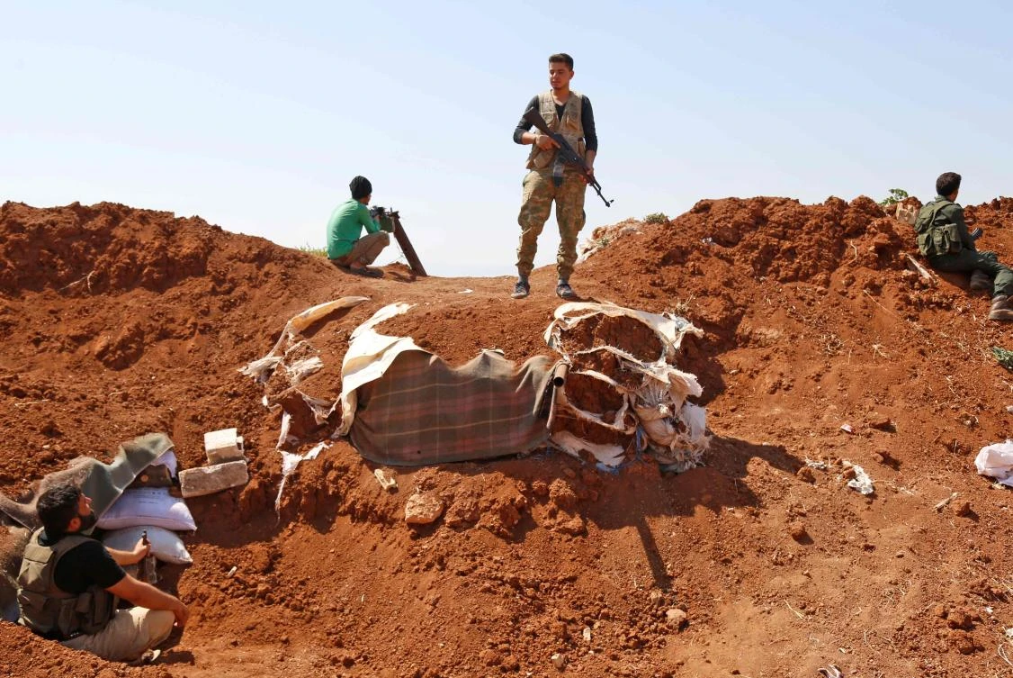 Syrian Rebel fighters prepare in anticipation of an attack by the regime on Idlib province and the surrounding countryside, in Kafr Zeta on August 30, 2018. (File/AFP)