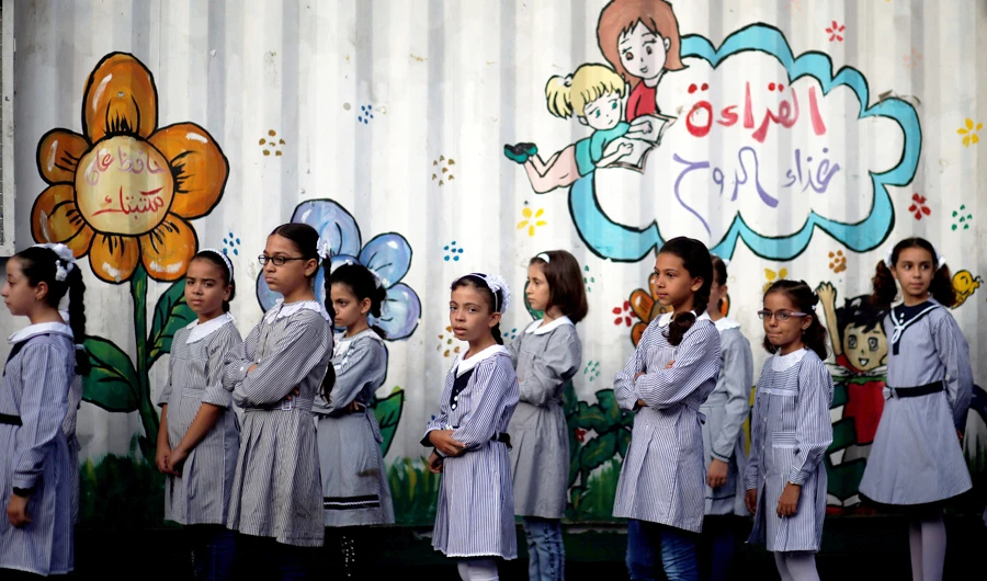 Palestinian schoolgirls queue at an UNRWA-run school. US has ended funding to the UN body supporting the Palestinians. (Reuters)