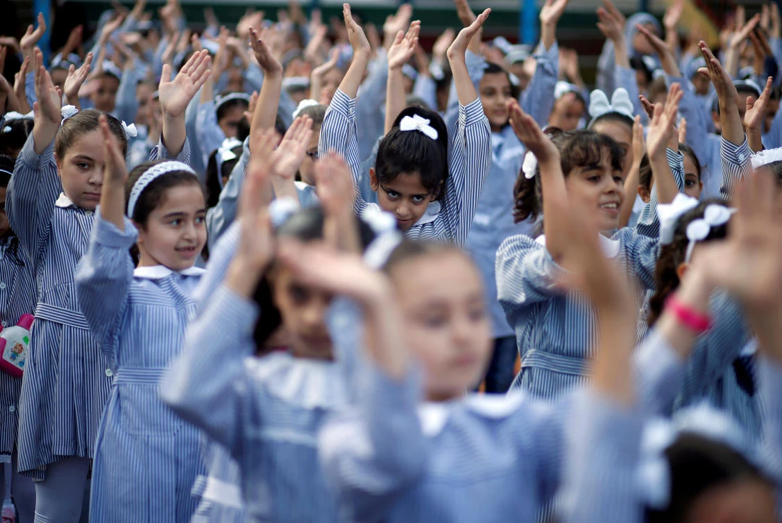 Palestinian schoolgirls participate in the morning exercise at an UNRWA-run school, on the first day of a new school year, in Gaza City August 29, 2018. (Reuters)