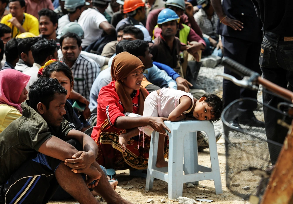 People of different nationalities are rounded up during a crackdown on illegal foreign workers in Malaysia in this 2015 file photo. There are an estimated half-a-million Bangladeshi migrant workers in Malaysia. (Shutterstock)