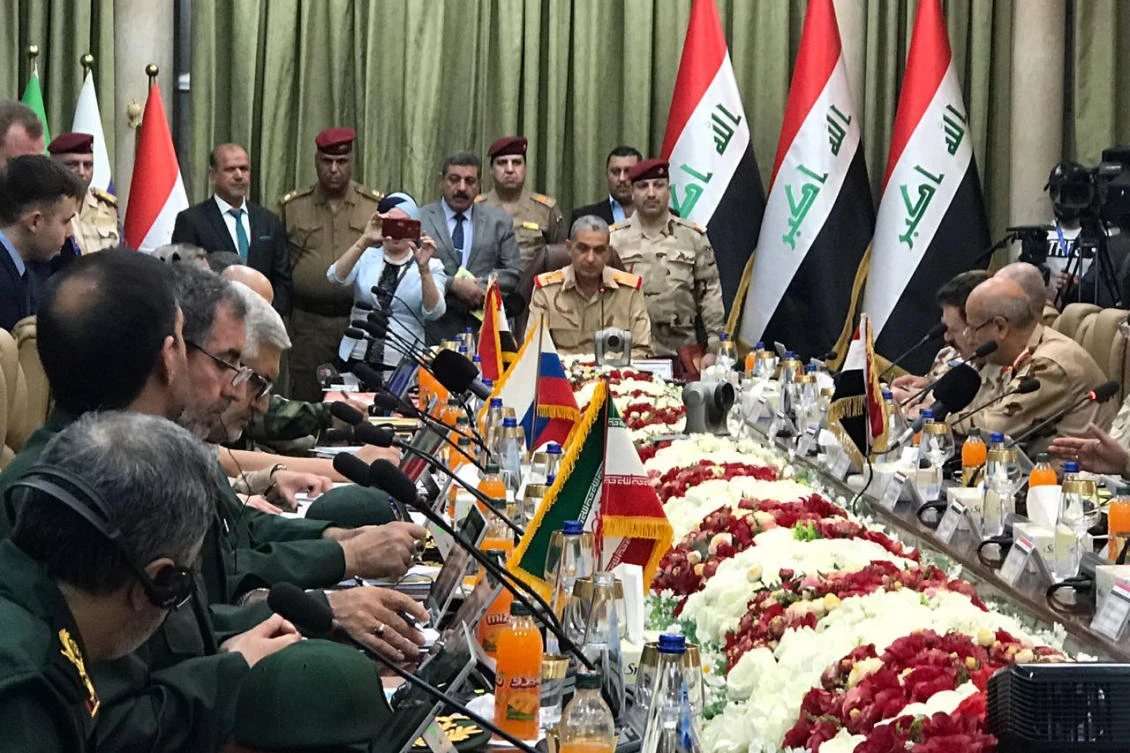 Iraqi military commanders (C) seated during a security cooperation and information-sharing meeting with their Iranian (L bottom), Syrian, and Russian counterparts in the Iraqi capital Baghdad. (AFP / Ho / Syrian State Television)