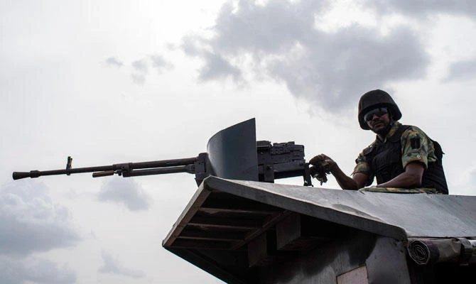 In this file photo taken on April 17, 2018 a member of the Nigerian Military Police sits on an armoured vehicle during the African Land Forces Summit (ALFS) military demonstration held at General Ao Azazi barracks in Gwagwalada. (AFP)