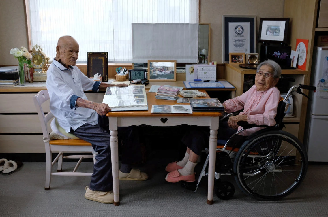 World’s oldest living married couple Masao Matsumoto, left, and Miyako Matsumoto look at albums in their room at a nursing house in Takamatsu, Kagawa prefecture in Japan. (Reuters)