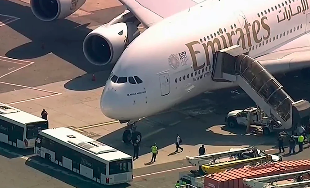 Emergency response crews gather outside Emirates flight EK203 at JFK International Airport in New York. (AP Photo)