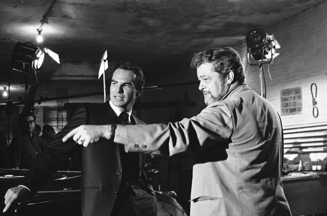 Burt Reynolds, left, discusses a scene with director Paul Bogart during location shooting of the ABC-TV series ‘Hawk,’ in New York, in 1966. Reynolds, who starred in films including ‘Deliverance,’ ‘Boogie Nights,’ and the ‘Smokey and the Bandit’ films, has died at the age of 82. (AP Photo)