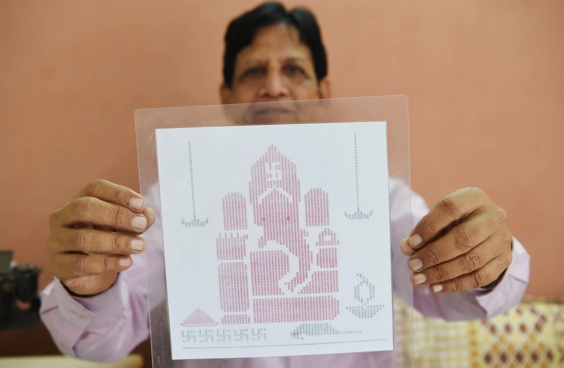 Indian artist Chandrakant Bhide shows an artwork depicting elephant-headed Hindu god Lord Ganesha which he created using a typewriter. (AFP)