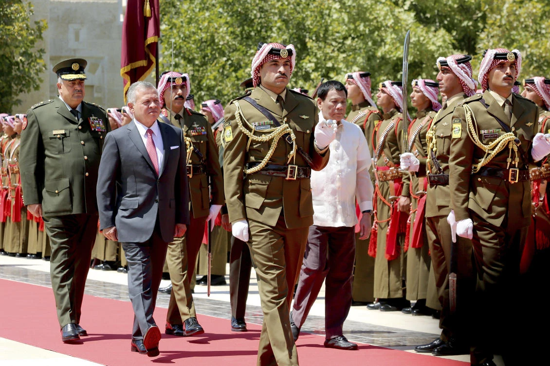Philippine President Rodrigo Duterte, right, and Jordanian King Abdullah II of Jordan review an honor guard at the Husseiniya palace in Amman on Thursday, September 6. (AP)