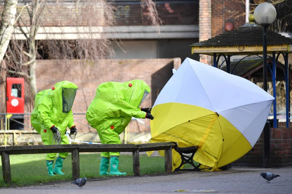 In this file photo, members of the emergency services fix the tent over the bench where a man and a woman were found on in critical condition at The Maltings shopping center in Salisbury, southern England. (AFP)