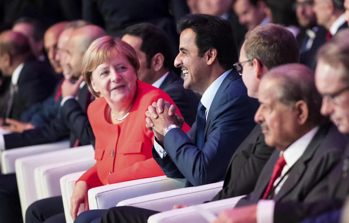German Chancellor Angela Merkel and the Emir of Qatar Tamim bin Hamad Al Thani at an investment forum in Berlin on Friday. (AP Photo)